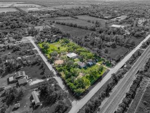 vacant land aerial shoot with green area and black and white soundings